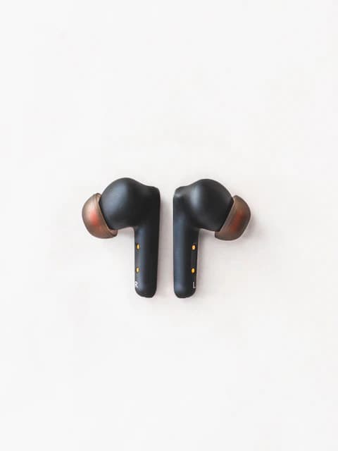 white surface, black wireless earbuds with charging case, trending electronics product, find products to sell on shopify, storelister product research
